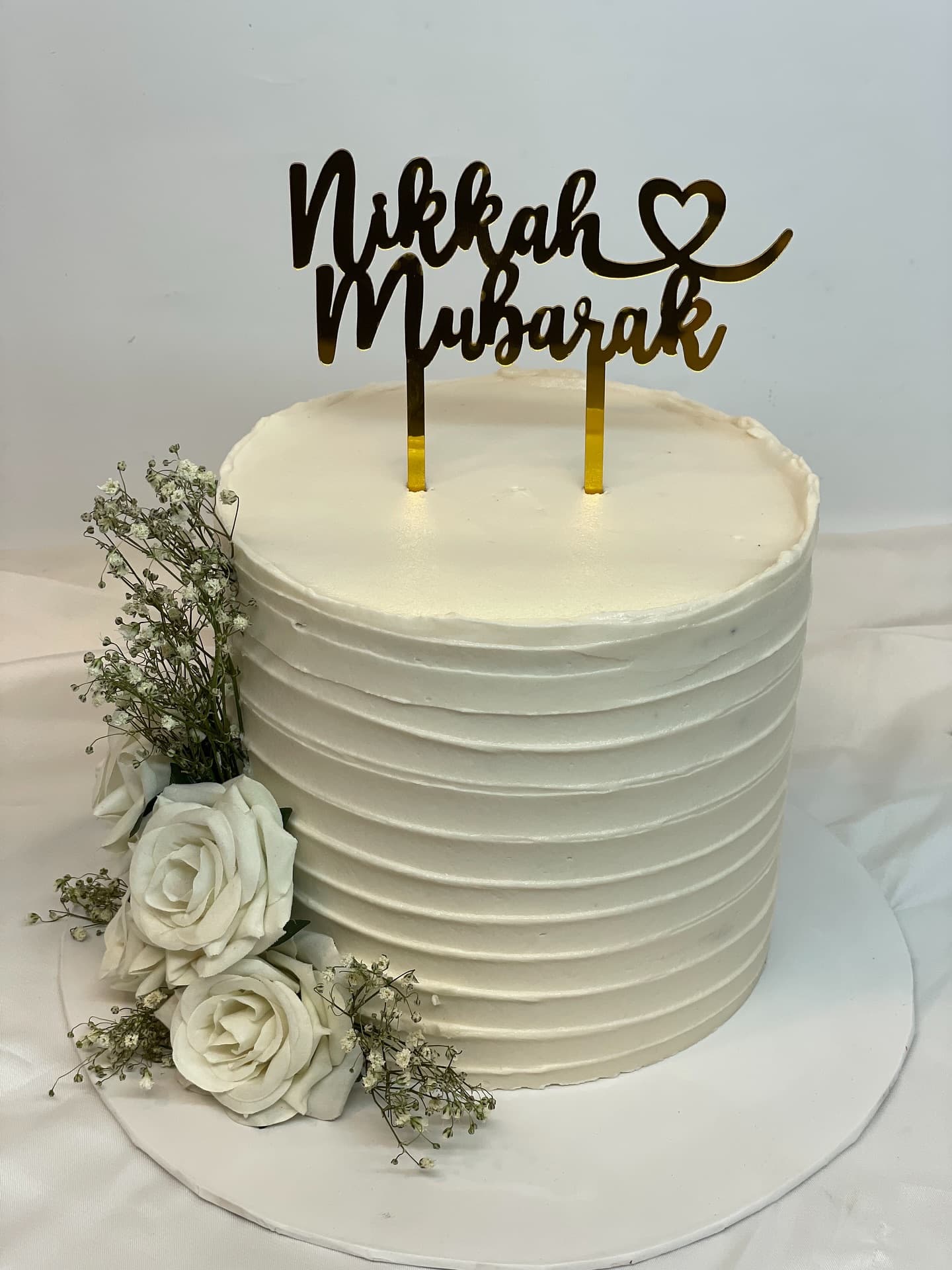 Custom cake lettered Nikah Mubarak, made for a wedding ceremony